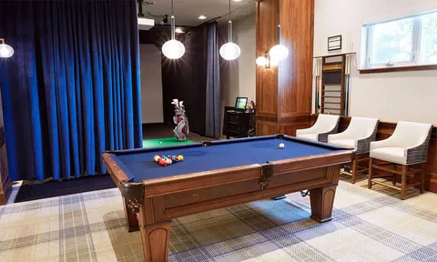 Billiards room with blue pool table and seating