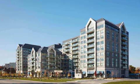 Residence towers with glass balconies beside landscaped sidewalks