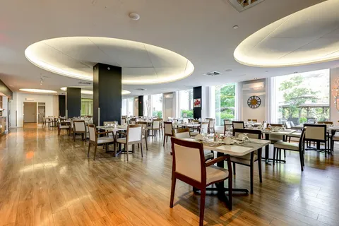 Dining room with set tables and circular recessed ceiling lights