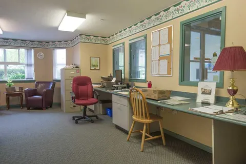 Hair salon with styling chairs, mirrors and a work counter.