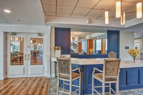 Bistro counter with cabinets, stools and beverage appliances.