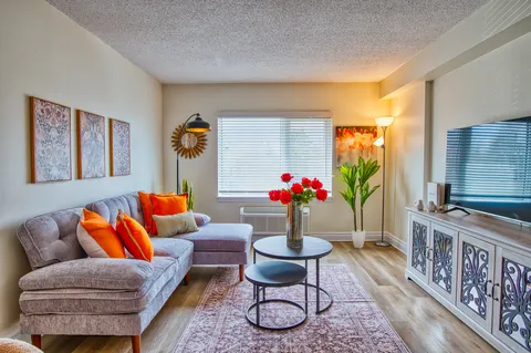 Suite living room with a sofa, television and coffee table.