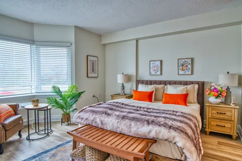 Bedroom with a double bed, bedside cabinets and a bench.