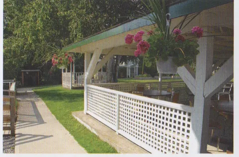 Covered porch beside a garden path.