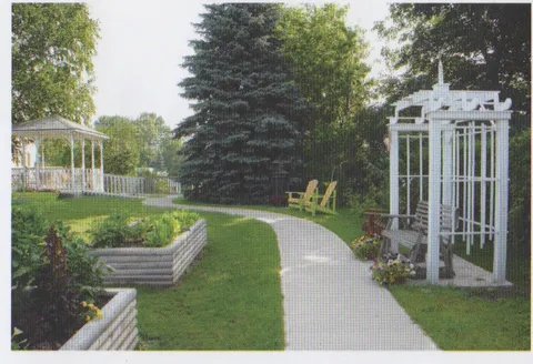 Garden paths, raised beds and white pergolas.