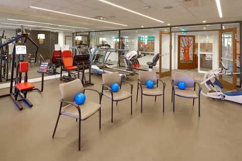 Fitness room with exercise machines and chairs