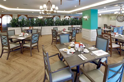 Dining room with set tables beside large windows