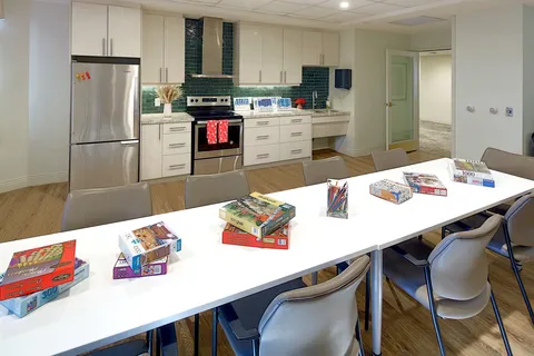 Activity room with worktables and a communal kitchen