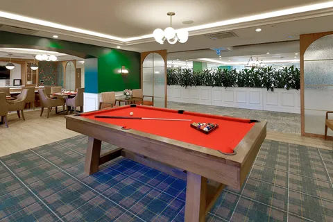 Games area with a red-felt pool table