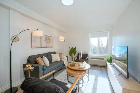 Suite living room with a sofa, armchair and large window