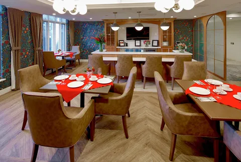 Pub seating with a counter and red table settings