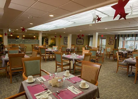 Dining area with set tables and seasonal decorations.