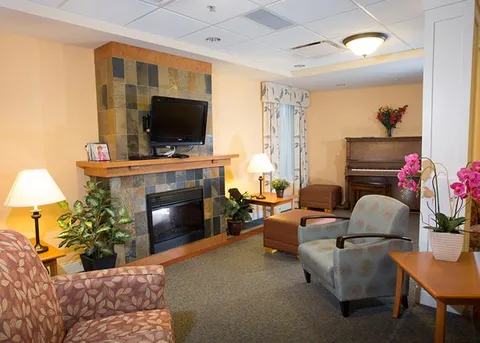 Lounge seating beside a fireplace and television.