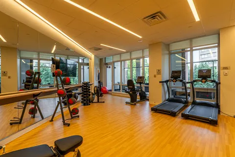 Exercise room with treadmills, weights and mirrored walls