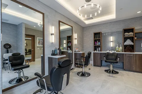 Hair salon with styling chairs, mirrors and cabinets
