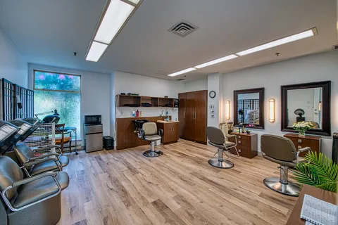 Hair salon with styling chairs, mirrors and wash basins.