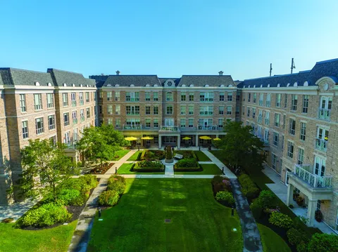 Four-storey brick building surrounding a landscaped courtyard