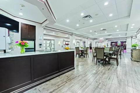 Dining area with tables, chairs and a long kitchen counter