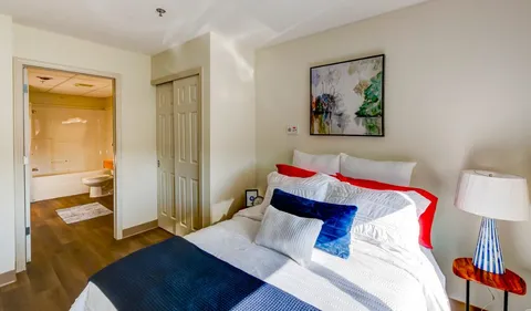Bedroom with a double bed and an open doorway to a bathroom