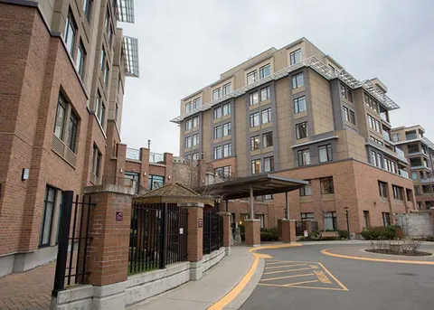 Multi-storey residence buildings around a paved entrance drive.