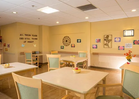Activity room with games tables and wall displays.