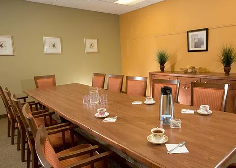 Private dining room with a long wooden table and chairs.