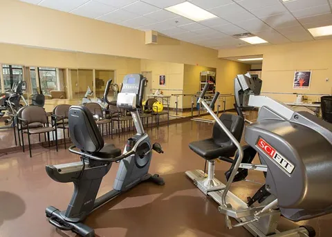 Fitness room with exercise bikes and strength equipment.