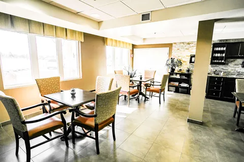 Small tables and patterned chairs beside counters and cupboards