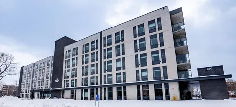 Residence building with rows of windows and snow beside the ground floor.