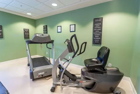 Exercise area with a treadmill, cross-trainer and stationary bicycle