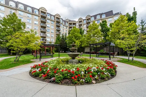 Residence overlooking a garden with a fountain and flower beds