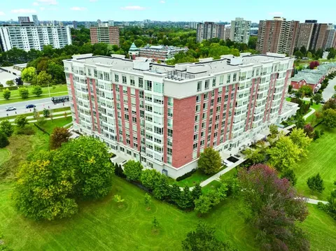 Aerial view of the residence surrounded by lawns and trees