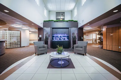 Seating area with two armchairs, a table and an aquarium