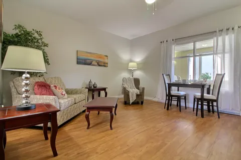 Sitting area with a sofa, armchair and small dining table