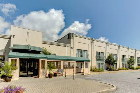 Low residence building with a covered entrance and planters