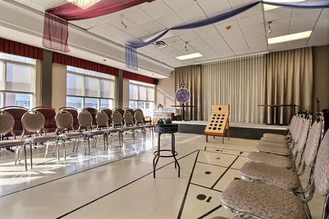 Activity room with rows of chairs and tabletop games
