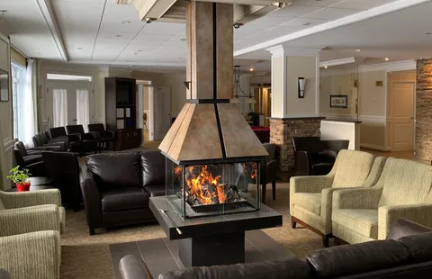 Common lounge around a central suspended fireplace.