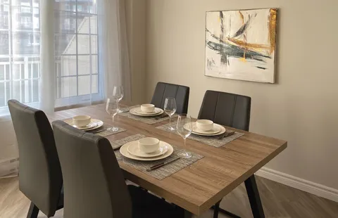 Apartment dining area with a wooden table and chairs.