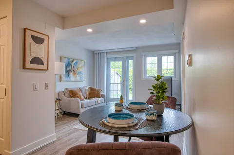 Suite living and dining area with upholstered seating and a round table.