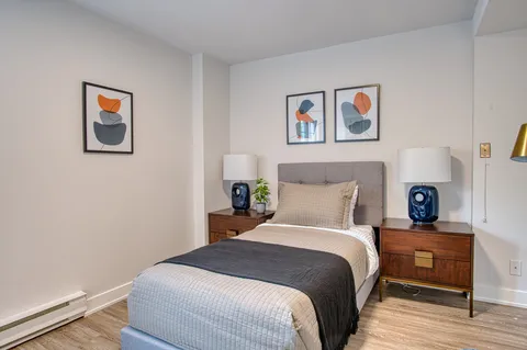 Bedroom with a double bed, bedside cabinets and lamps.