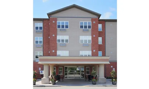 Front of the multi-storey residence above a covered entrance.