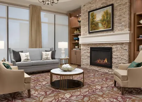Lounge with sofas, armchairs and a stone fireplace.