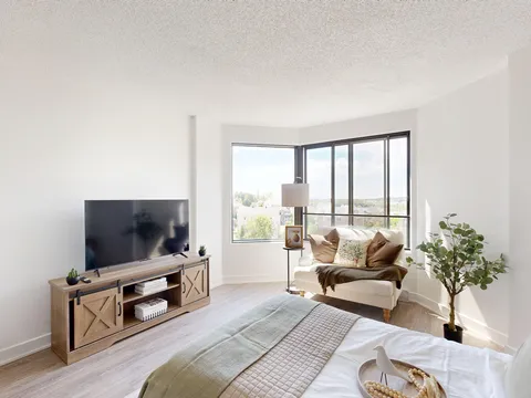 Living room with sofas, a television and a dining area.