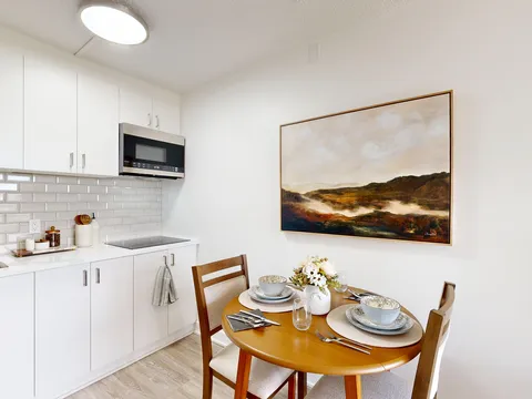 Open kitchen and dining area with a round table.