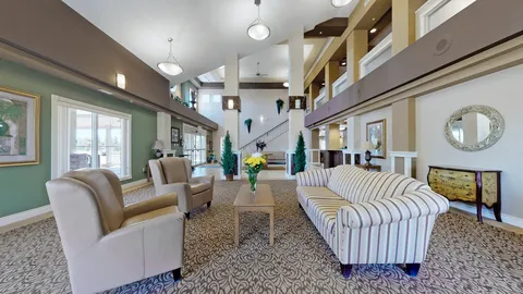 High-ceilinged seating area with sofas, armchairs, lamps and mirrors