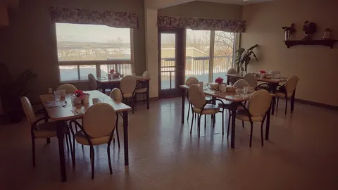 Dining tables and chairs beside windows overlooking the water