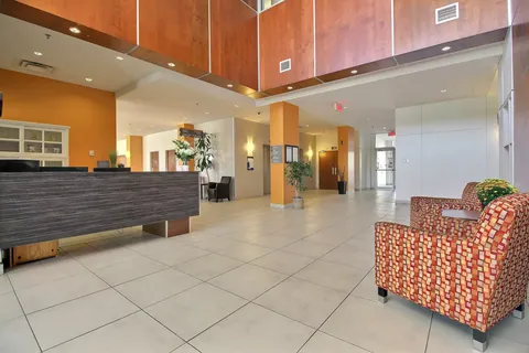 Reception area with a long desk and patterned armchairs