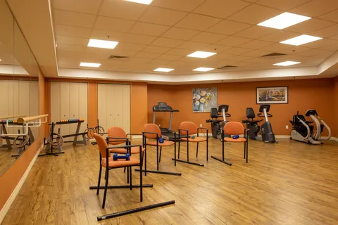 Fitness room with exercise equipment and chairs