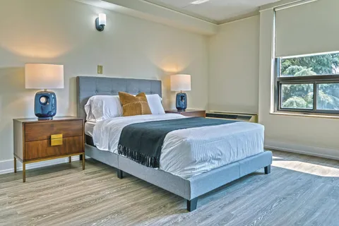 Bedroom with a double bed and blue bedside lamps