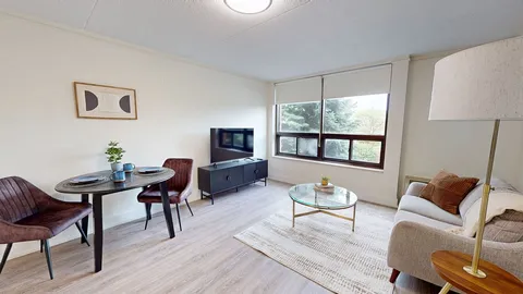 Suite living room with a sofa, dining table and television